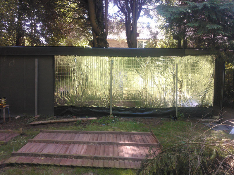 I wanted to camoflage the back of the shed and keep costs down, so I used roofing felt for the back,